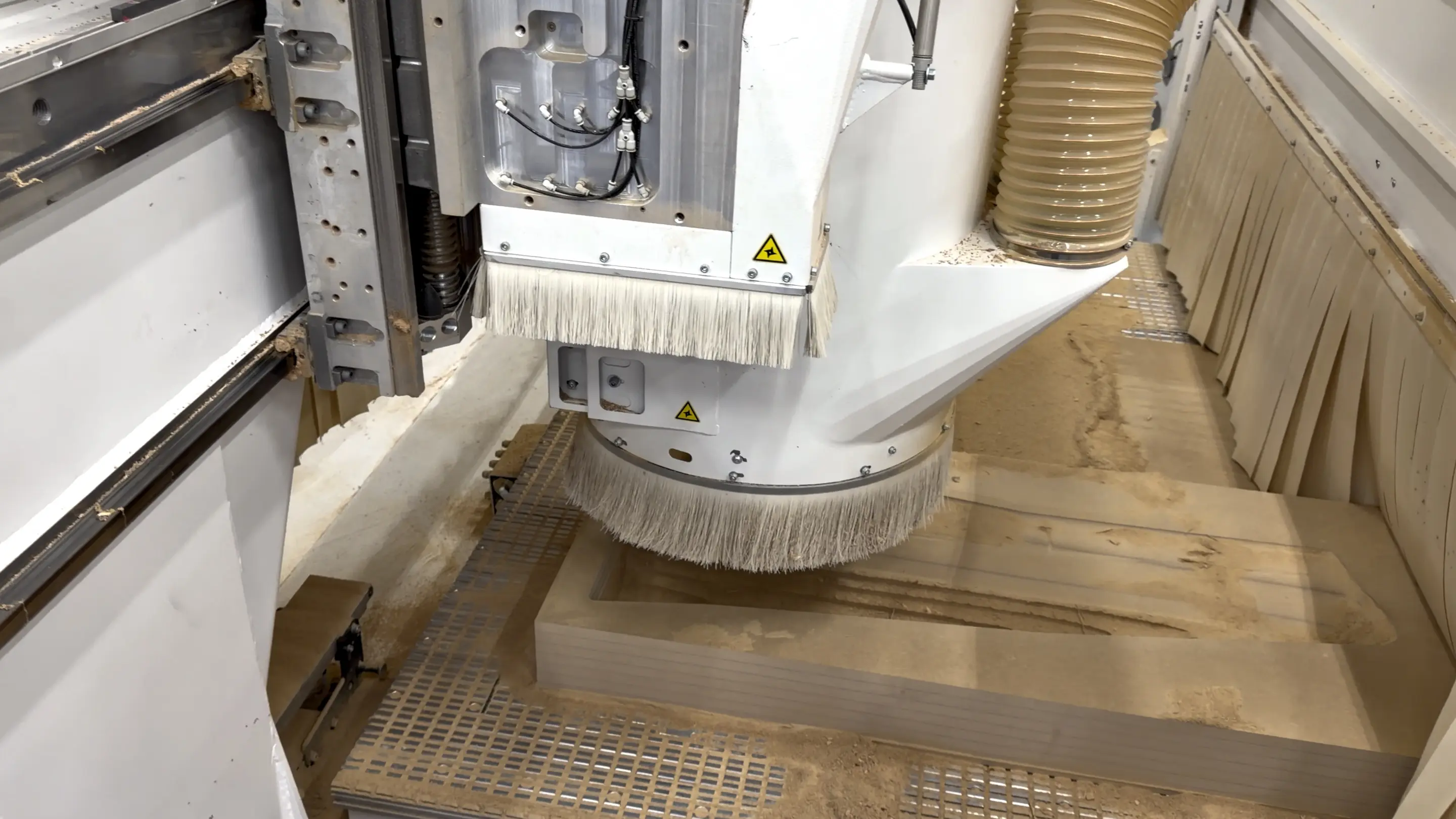 Gantry mill machining an MDF negative mold on the vacuum table for a CNC-milled trade show exhibit
