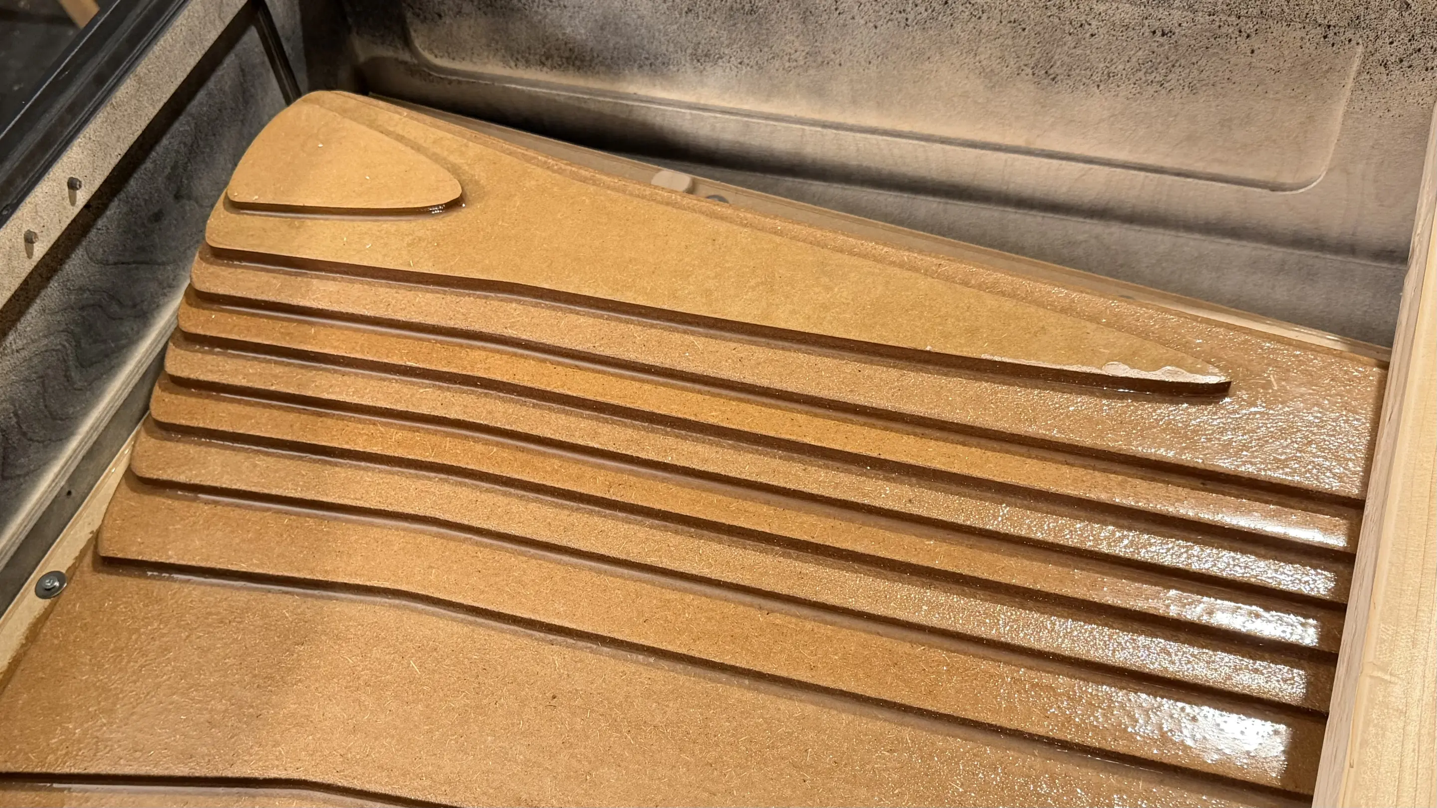 Underside of the MDF negative mold inserted into the housing with stepped CNC-milled areas
