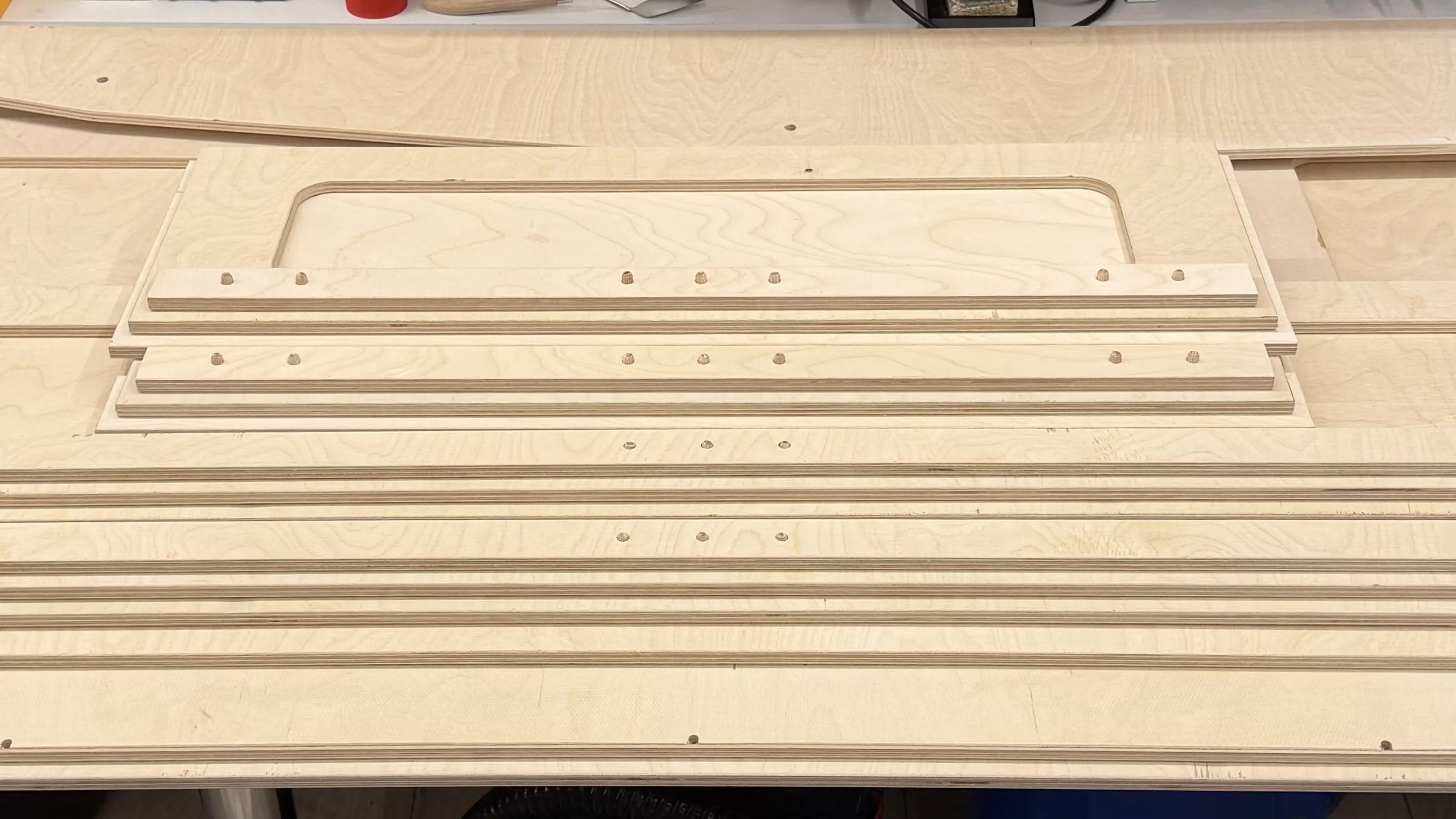 CNC-milled plywood side panels with cutouts for a lightweight and stable housing of the exhibit model