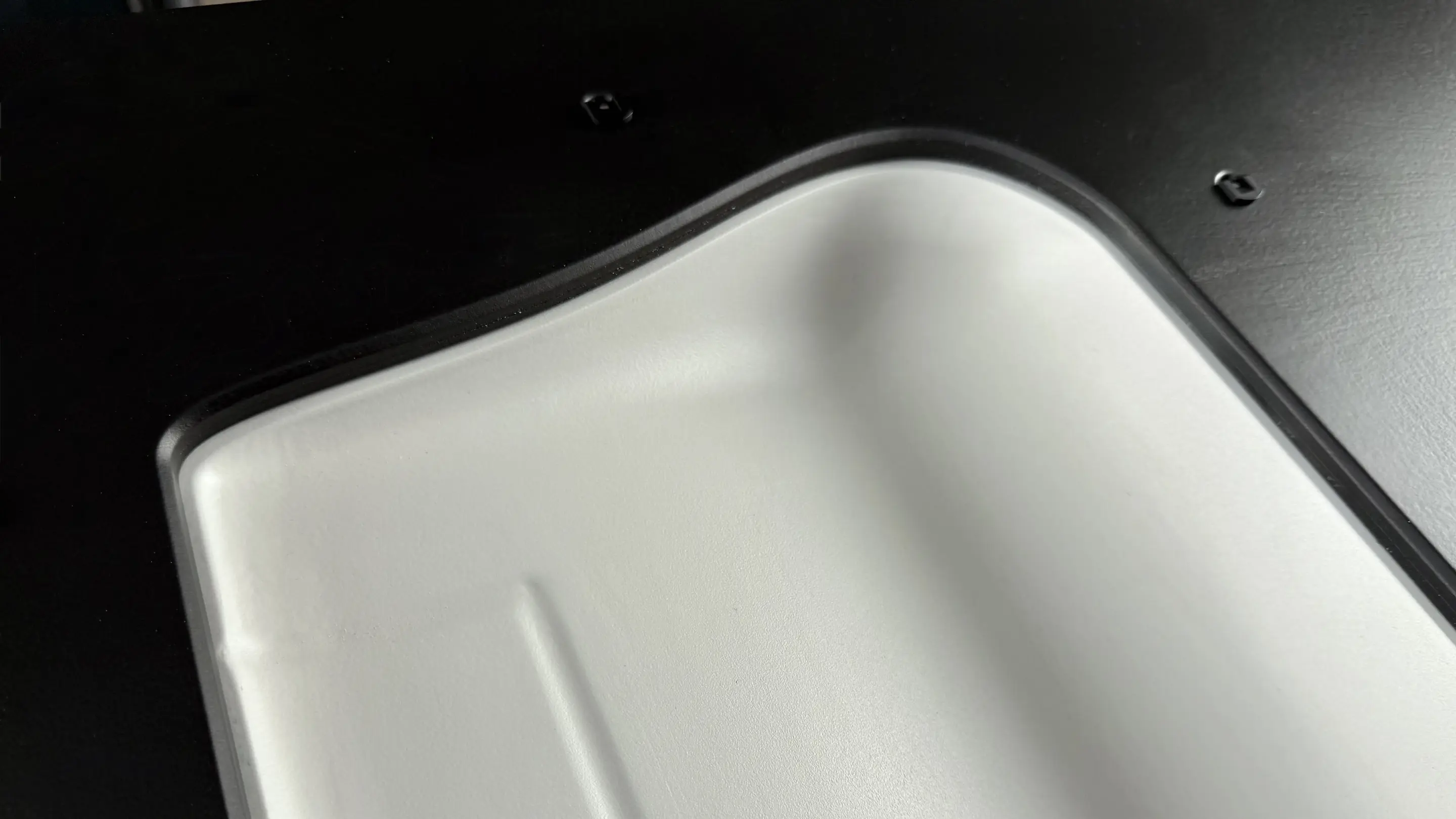 Matte light-grey painted wing tip of a CNC-milled wing negative mold in the black trade show exhibit