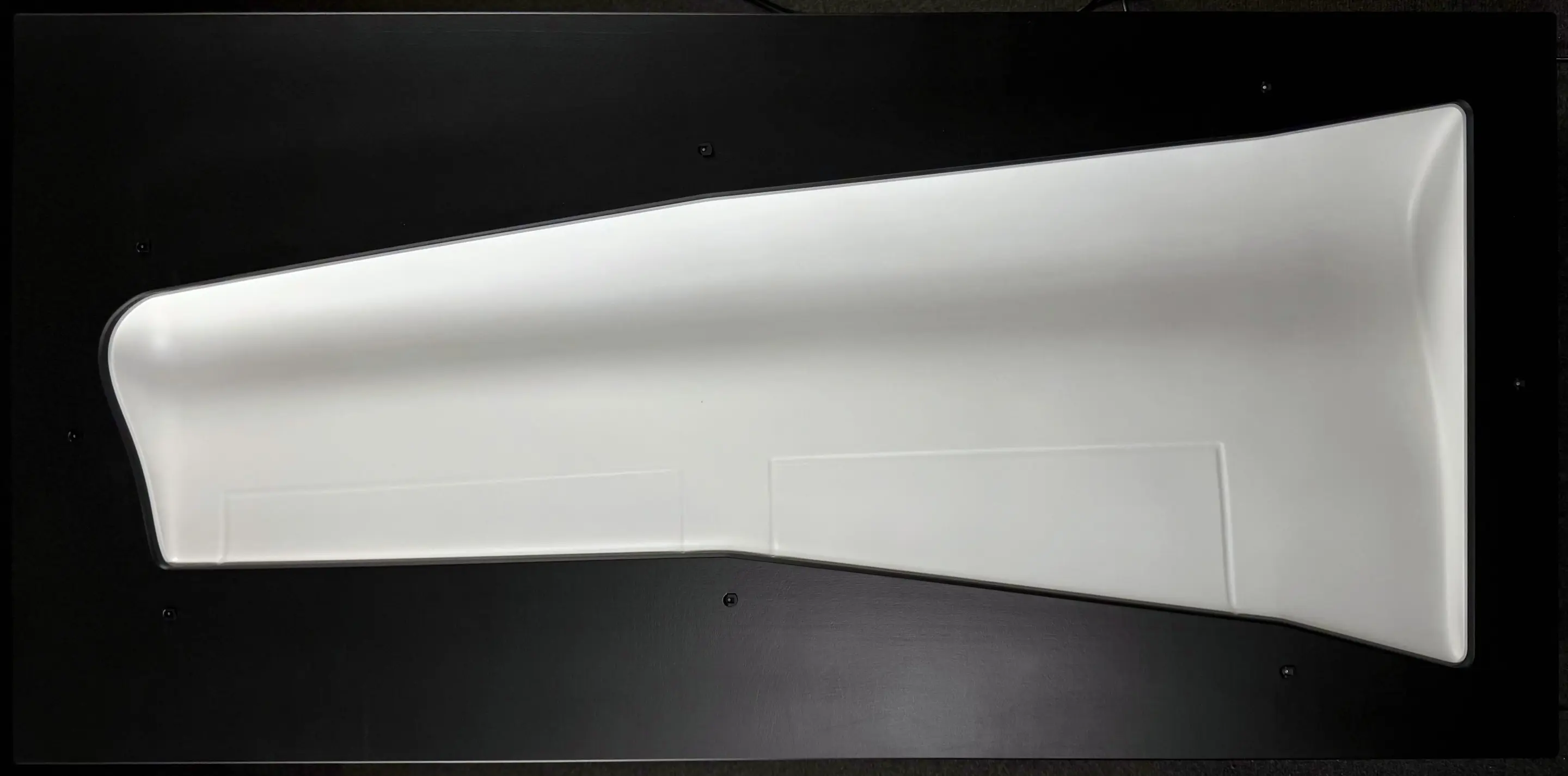 Top view of the painted CNC-milled form in light grey and deep black, casting shadows and showing a plastic 3D effect
