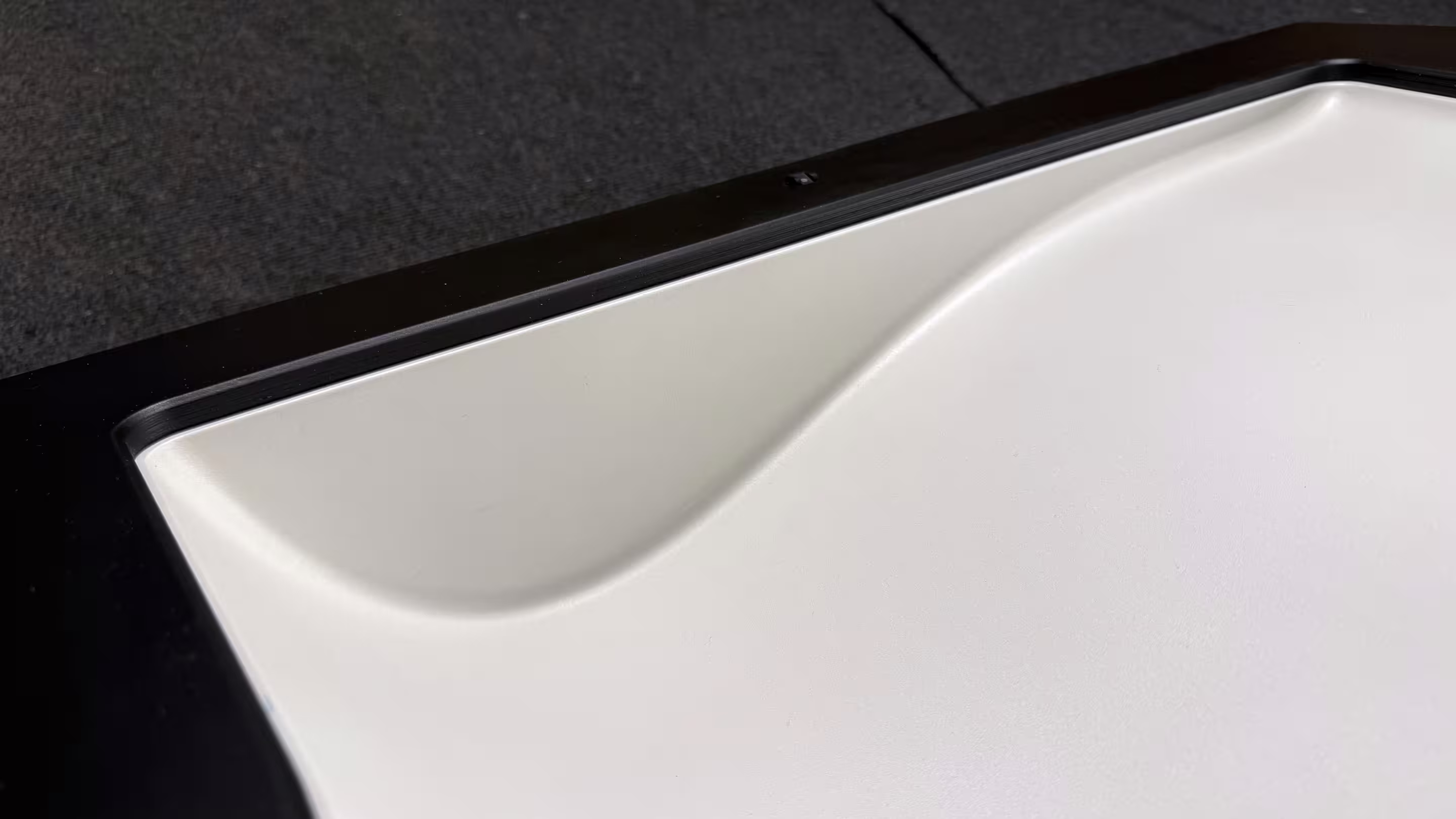 Painted leading section of a wing negative mold with a light surface and black housing for laser projection