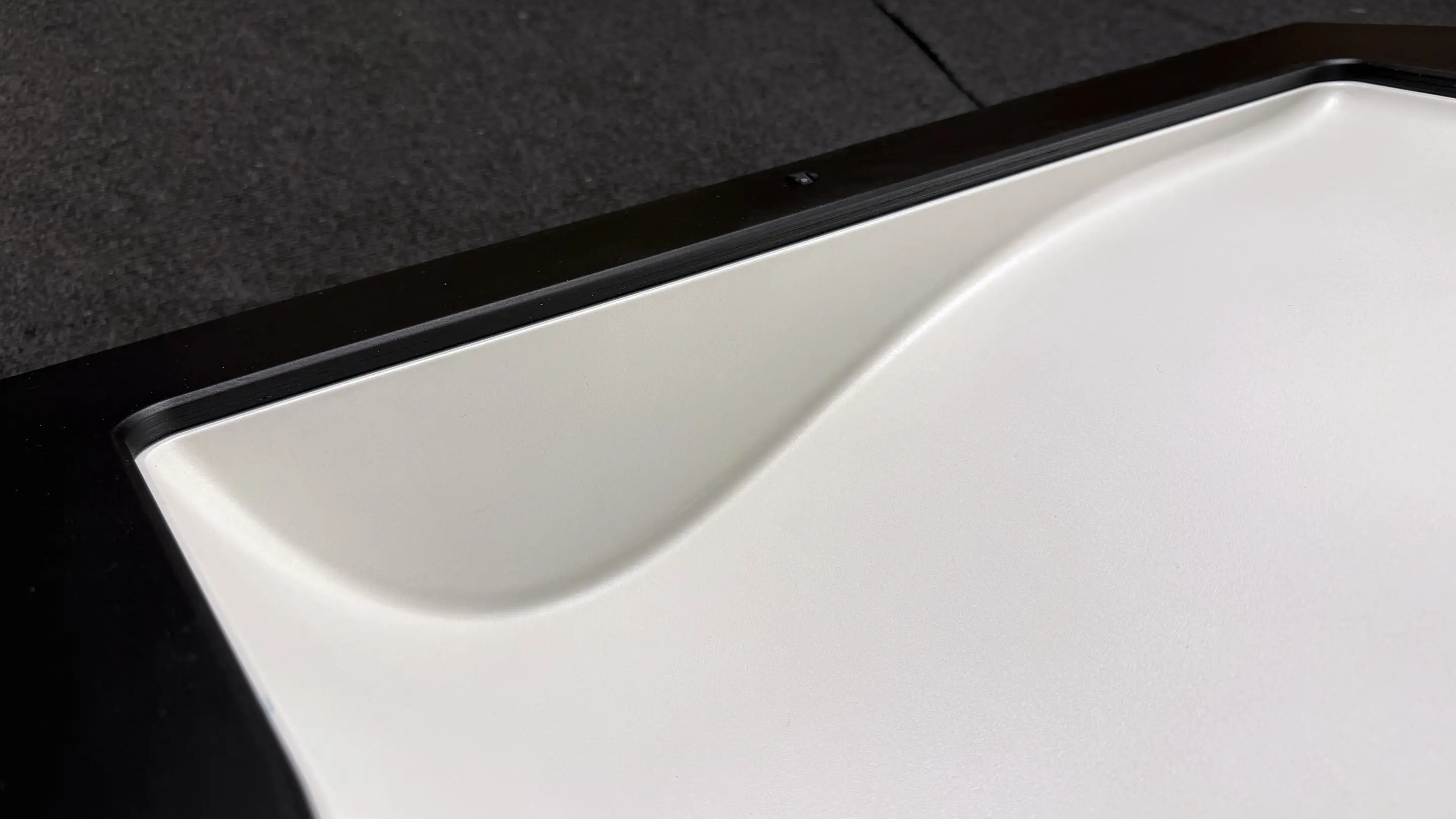 Painted leading section of a wing negative mold with a light surface and black housing for laser projection